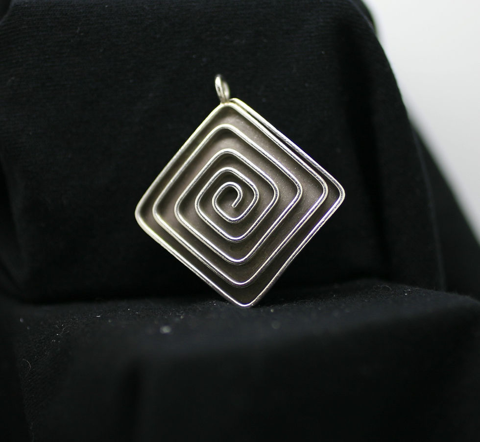 Thai silver square bead with hoop on one corner, concave smooth on one side and maze-like pattern on the other