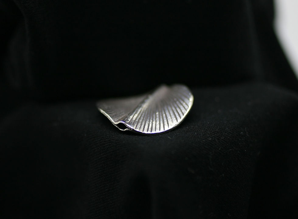 Thumbnail: Fine silver circular spiraling bead with a central ridge and peacock-like grooves