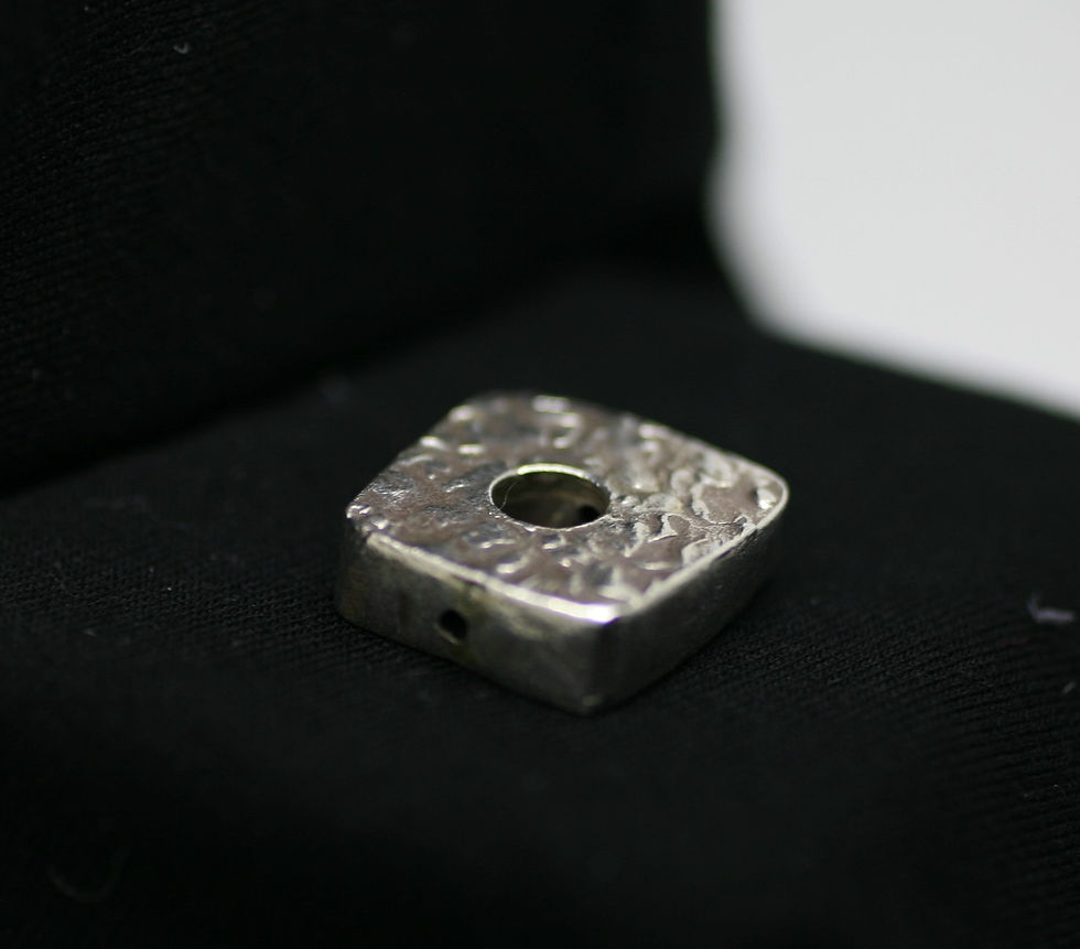 Thumbnail: Thai silver bead with square shape and central hole with a unique surface pattern
