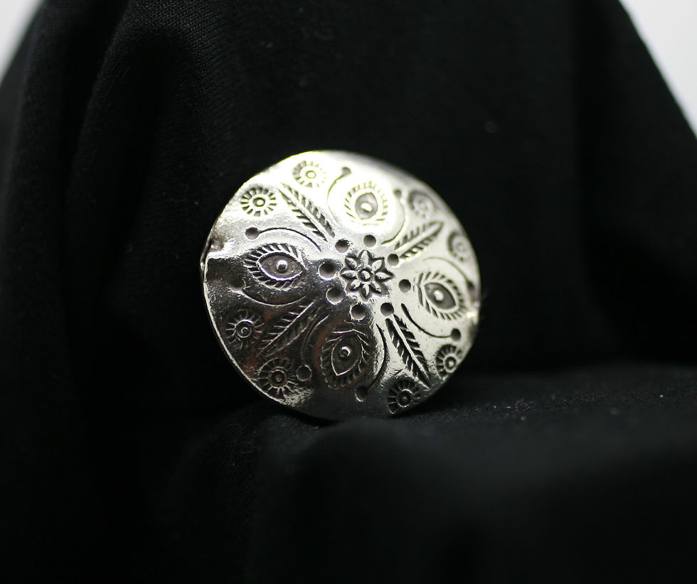 Thai silver circular bead with exotic flower patterns grooved into the smooth surface