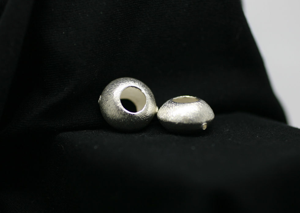 Thumbnail: Two Karen Hill Tribe silver circular beads with hollow center circles featuring fine bark like surface textures