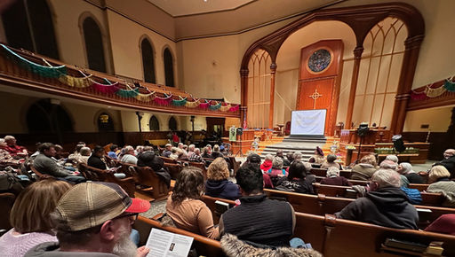 Audience in sanctuary watching film.