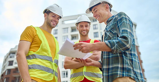three-men-with-drawing-discussing-construction-site.jpg