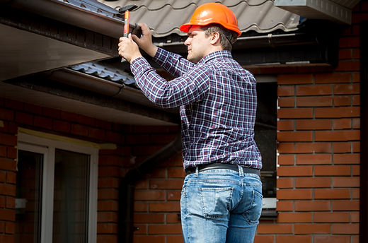professional-carpenter-hammering-roof-boards-with-hammer.jpg