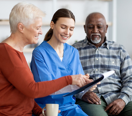 cheerful-young-woman-doctor-having-conversation-with-senior-patients.jpg