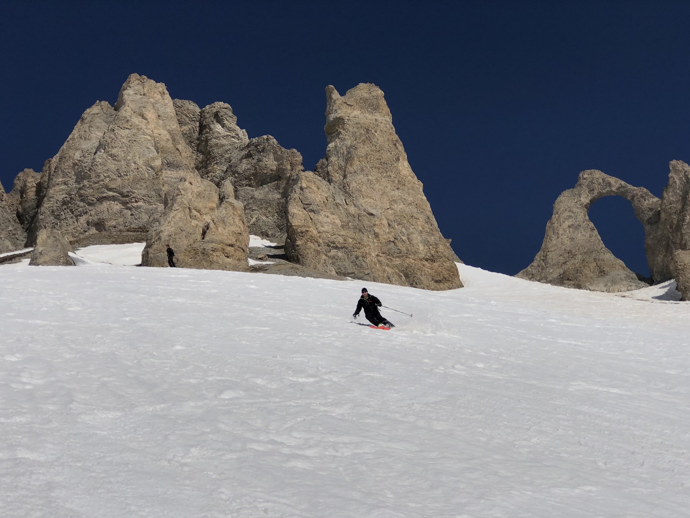 Skifahrer abseits der Piste unter der Aiguille Percée in Tignes, mit ihren Felstürmen und dem natürlichen Felsbogen
