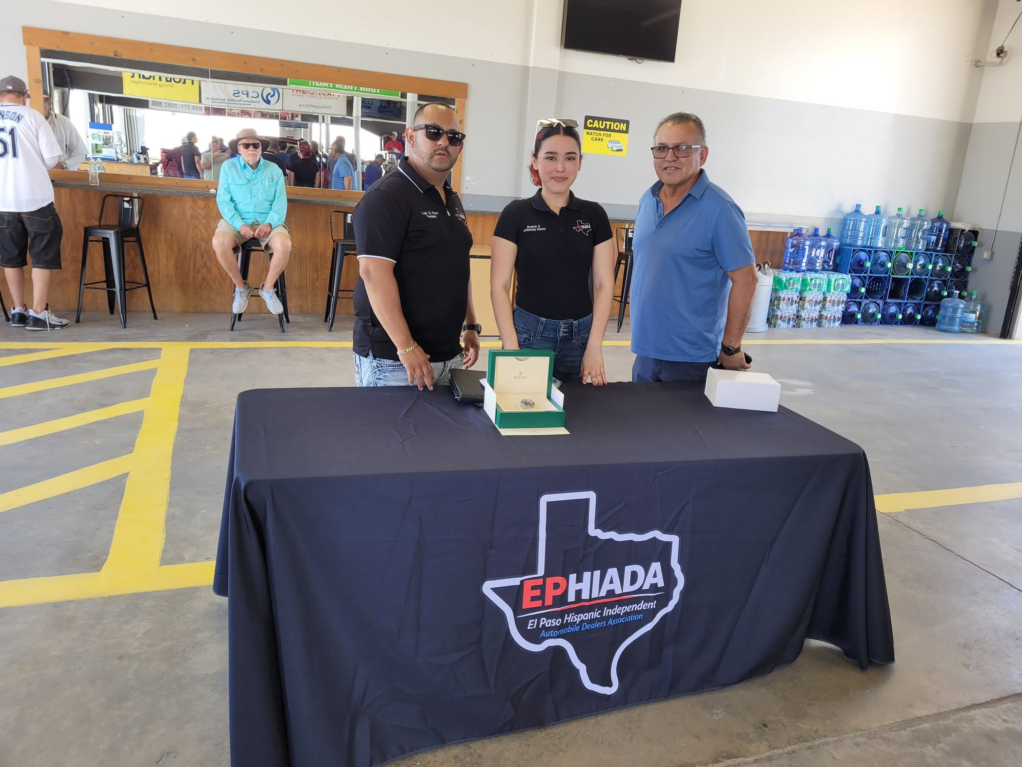 EPHIADA representatives behind an association table with a raffle prize on display.