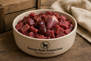 Close-up of raw dog food in a ceramic bowl on a rustic wooden surface with natural styling and warm lighting.