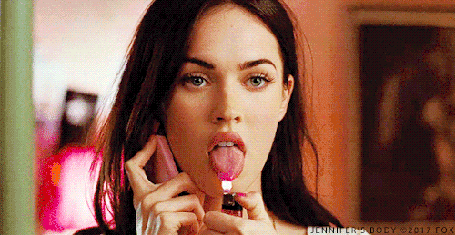 Megan Fox with her tongue out, setting it aflame while she talks on the phone