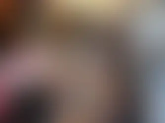 A group of people at Slow Fashion Socials, working round a table, cutting and sticking with textiles