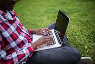 close-up-afro-american-hands-typing-laptop-green-grass.jpg