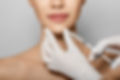 Syringe near woman's chin, beauty injections with fillers for chin shape correction. Cropp