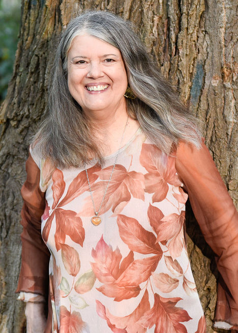 Smiling woman in floral dress outdoors with natural lighting in Santa Rosa