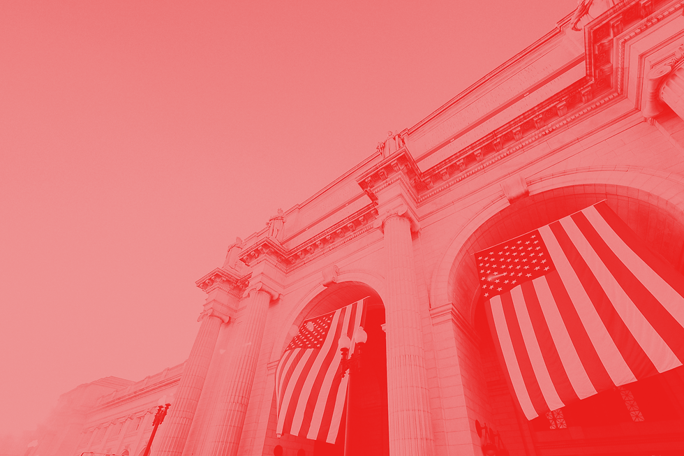 A federal building decorated with american flags.