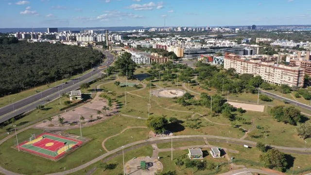 Aerial view of a city park with green spaces and playgrounds