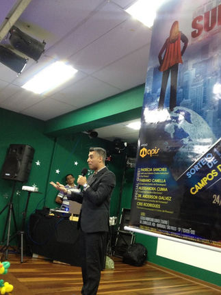 Man giving presentation, "Success," poster visible