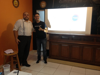 Two men at presentation, smiling