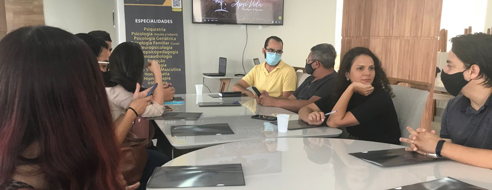 Team meeting around table, masks present