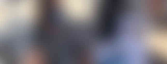 Nurse checking patient's blood pressure outdoors