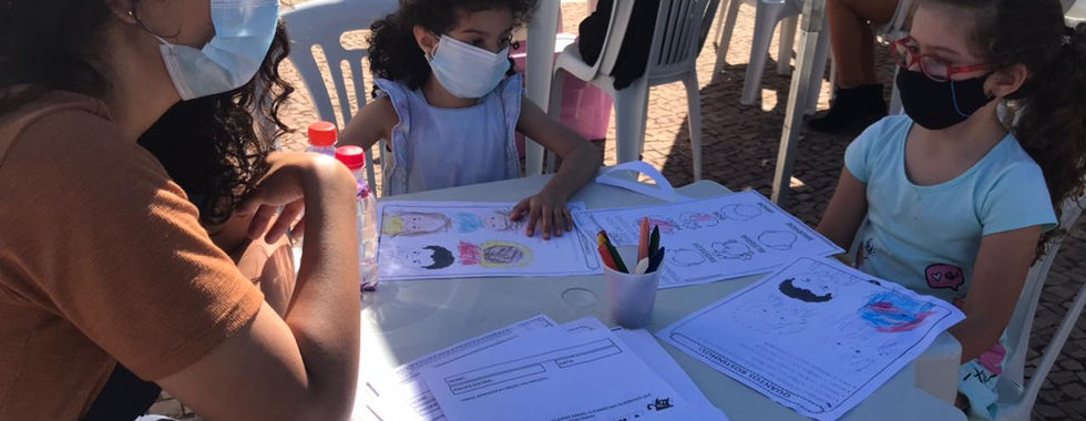 Children and adult coloring together outdoors