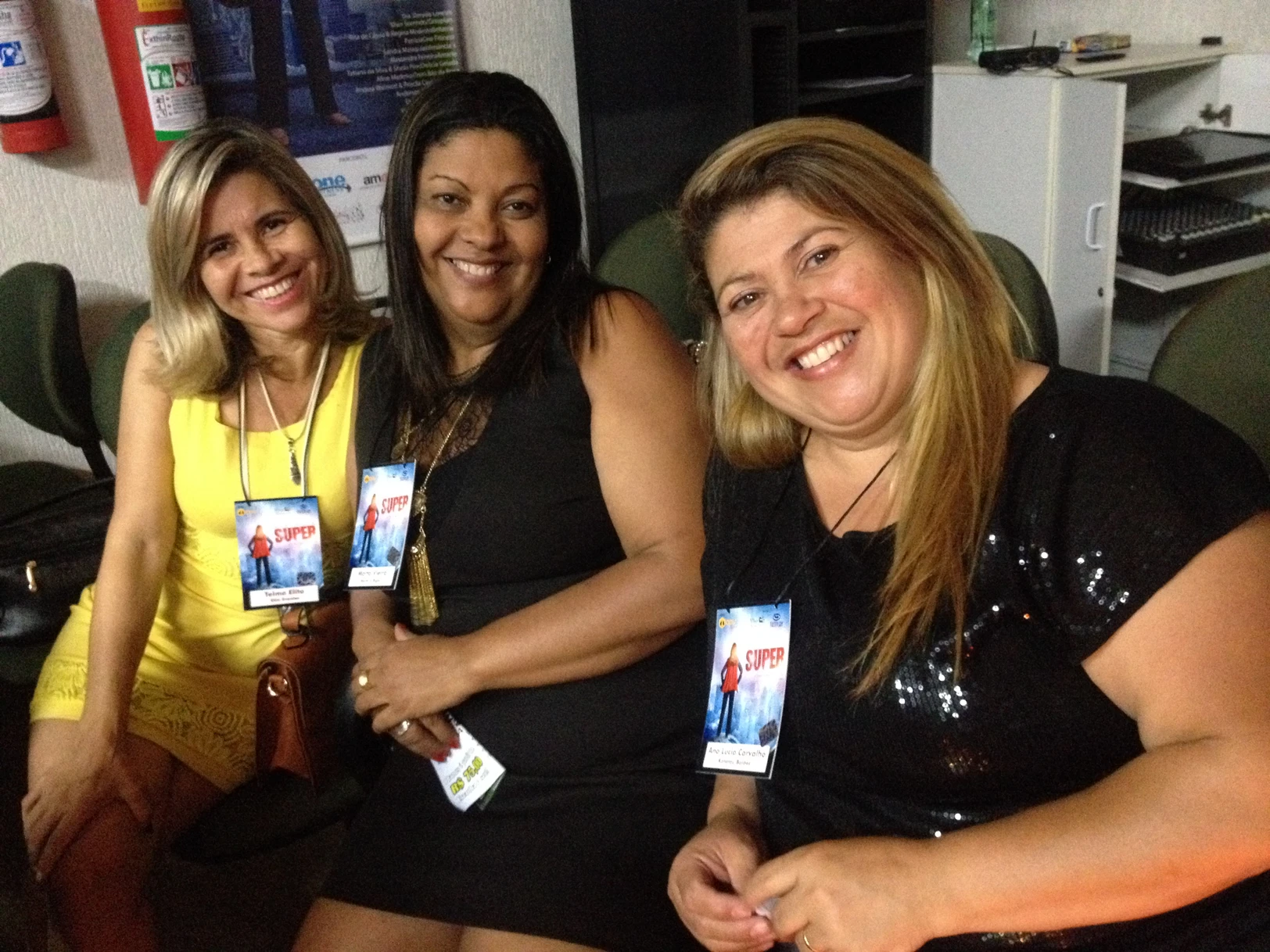 Three smiling women at conference