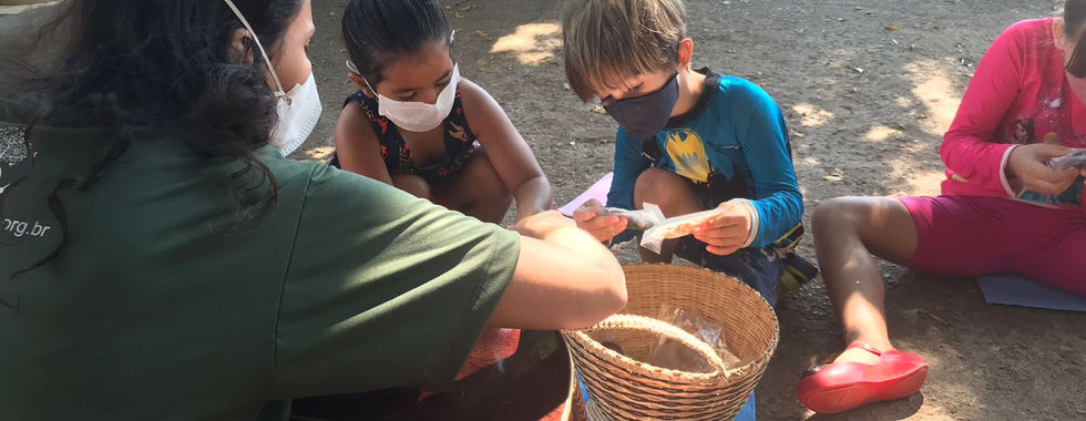 Adult and children with masks crafting with basket