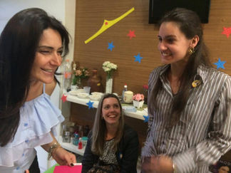 Three women smiling at a business meeting