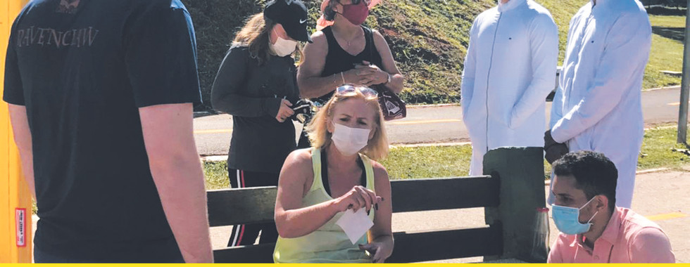 People in masks enjoying outdoor event