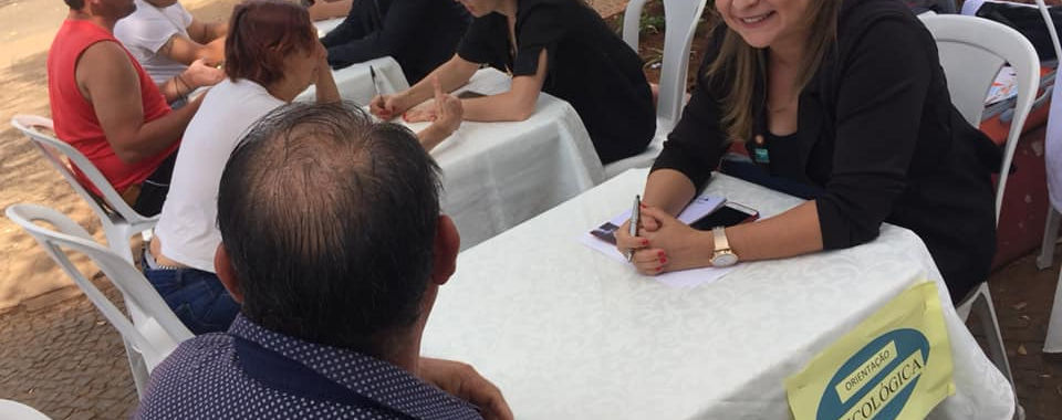 Woman consulting people at outdoor table