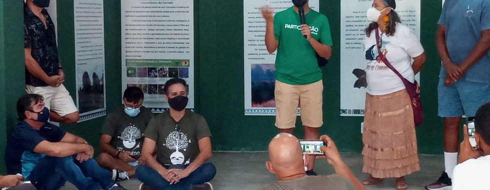 Group presentation, masked individuals, seated audience