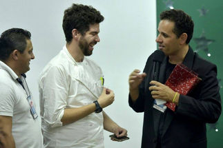 Three men smiling and conversing