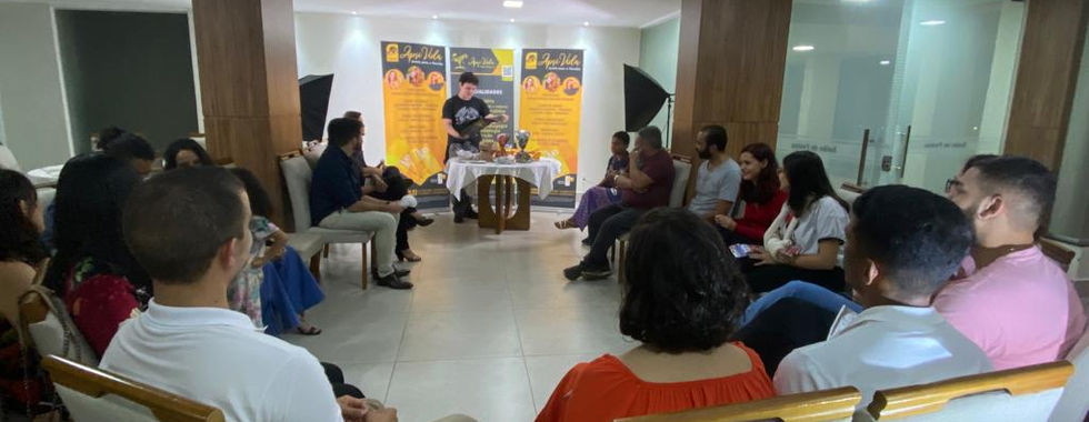 Group meeting: people seated in chairs, listening to a speaker.