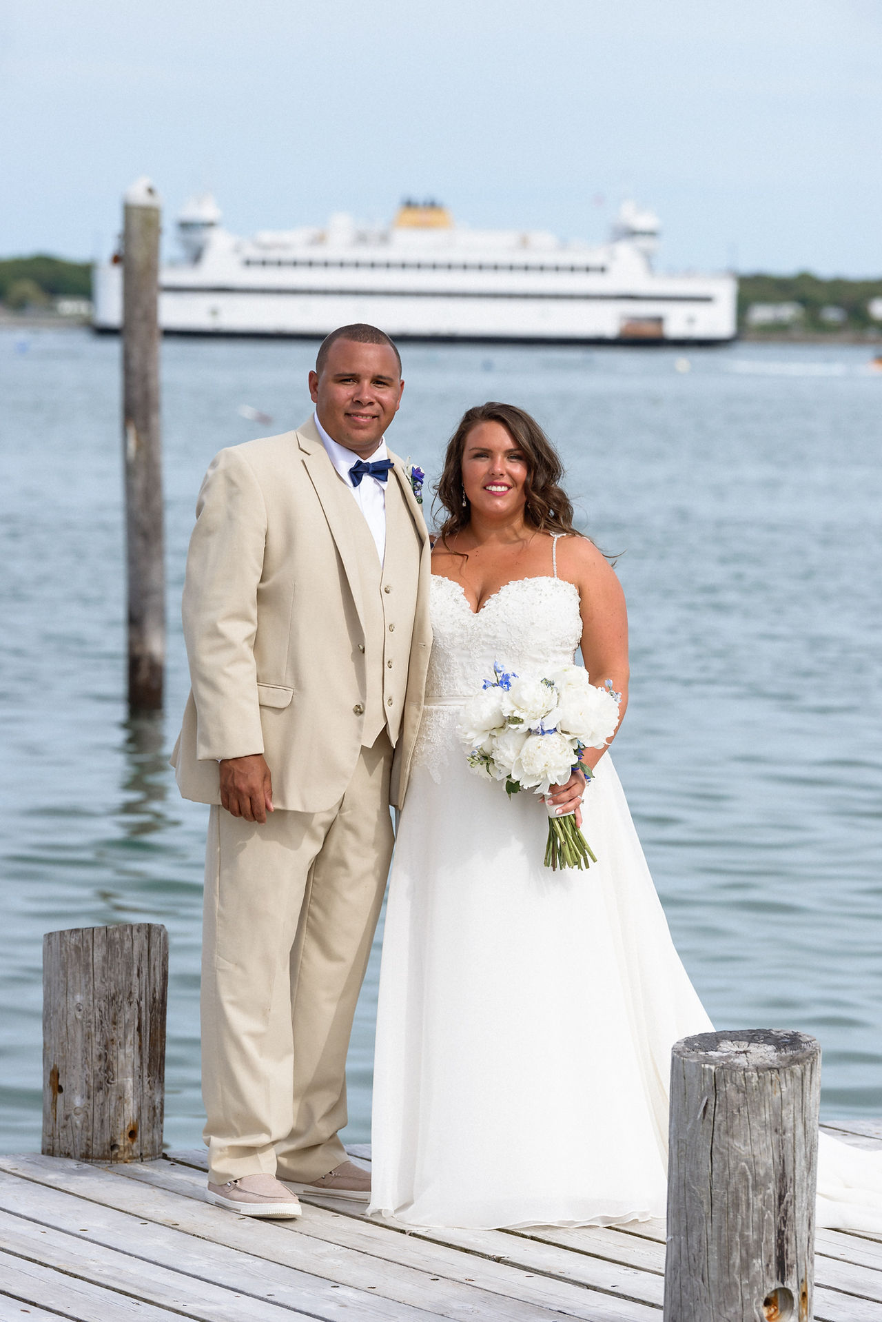 A bride and groom pose for a photo at the Vineyard Haven Yacht Club photo by David Welch Photography