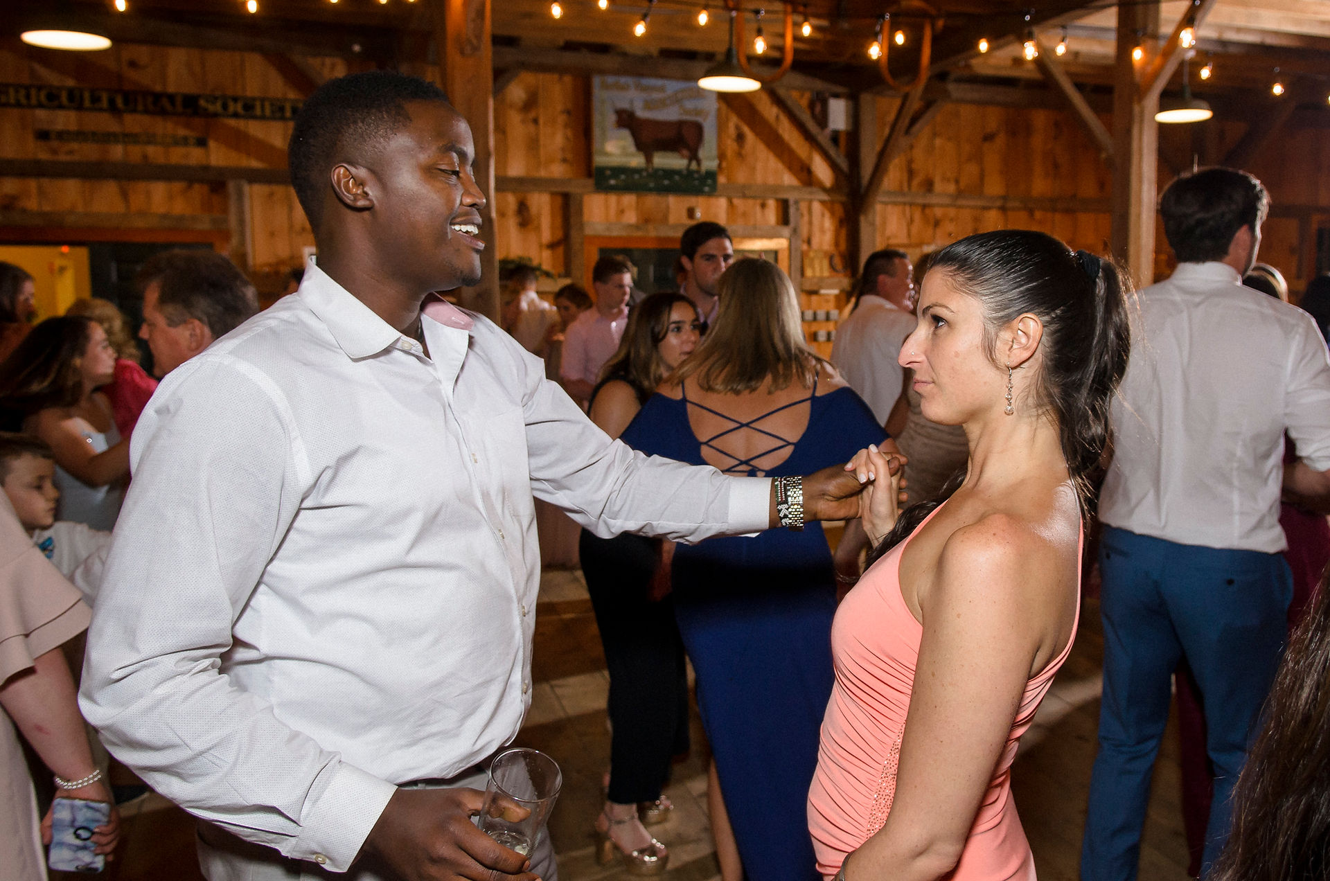 A wedding reception dance party at the Martha's Vineyard Agricultural Society Ag Hall photo by David Welch Photography