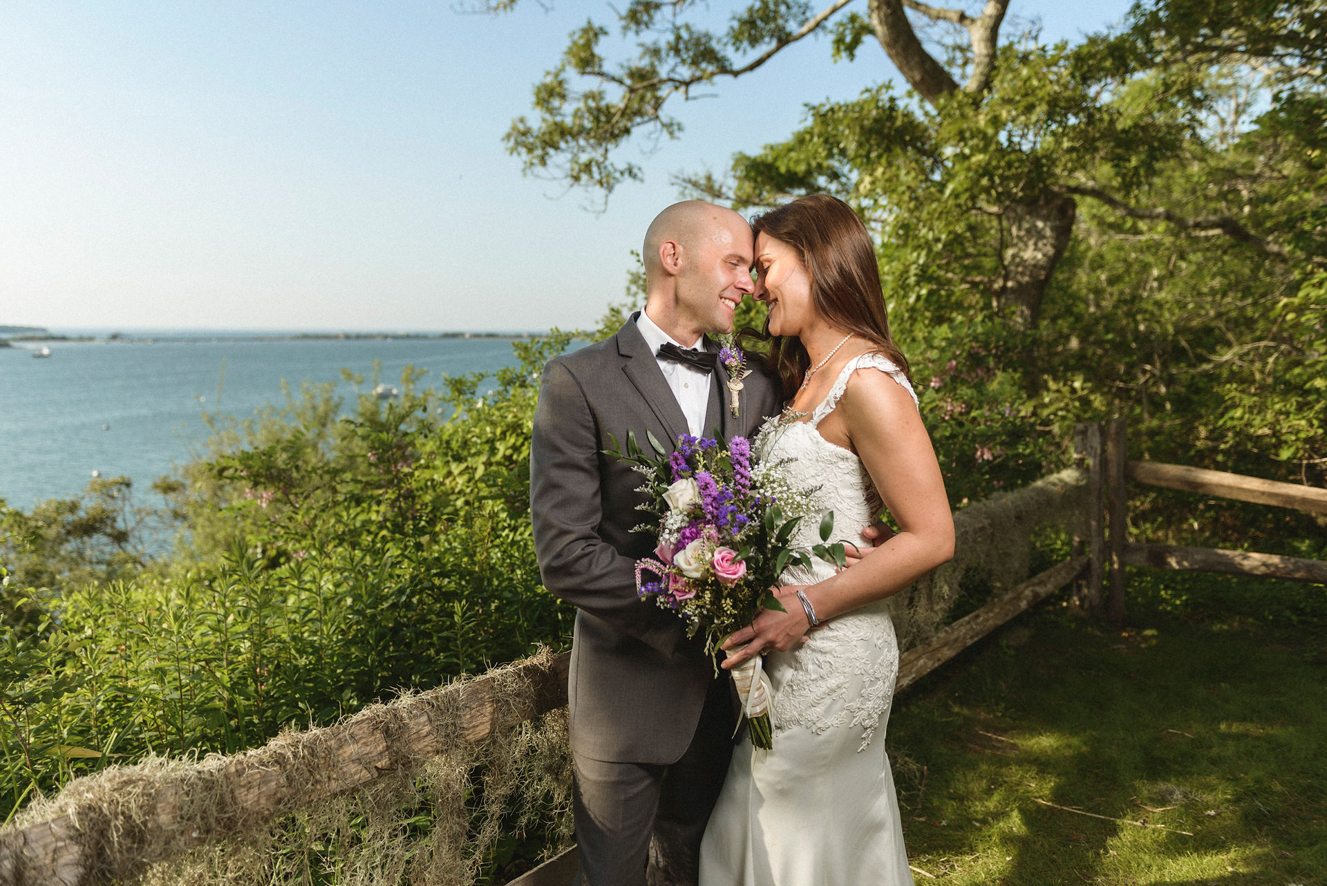 A bride and groom by a Lagoon Pond overlook at the Sailing Camp Park in Oak Bluffs photo by David Welch Photography