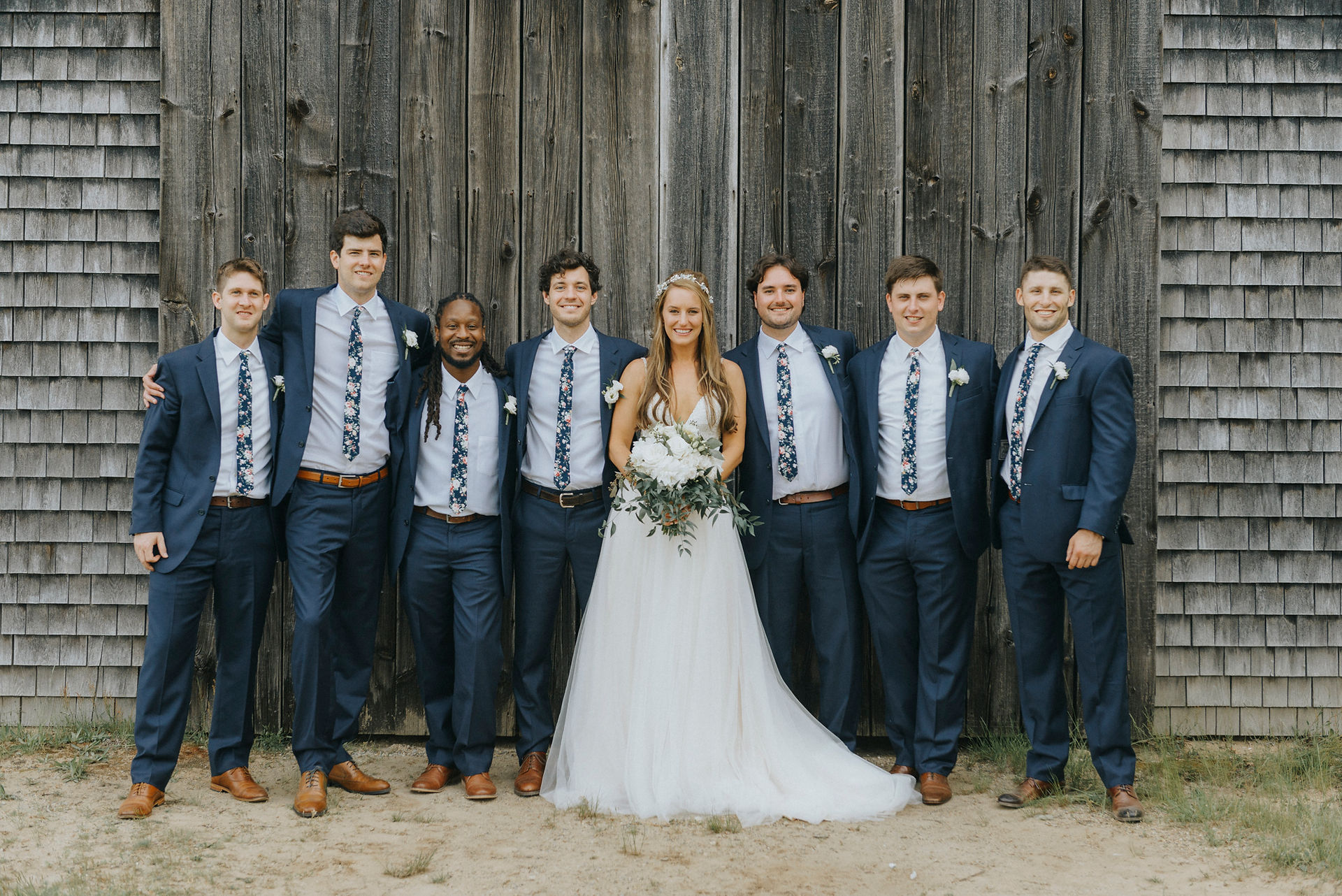 A wedding party poses for photos at a barn in West Tisbury photo by David Welch Photography