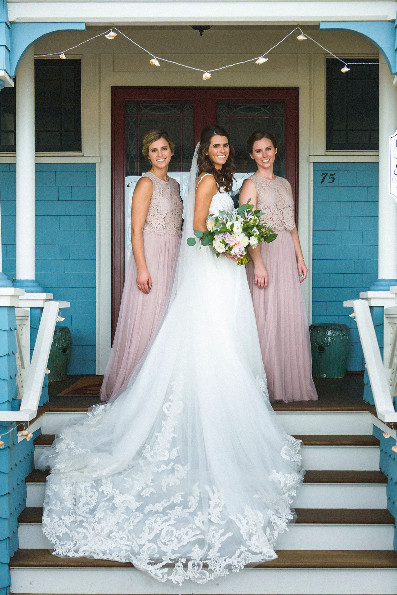 A bride and two bridesmaids on a cottage porch in Oak Bluffs photo by David Welch Photography