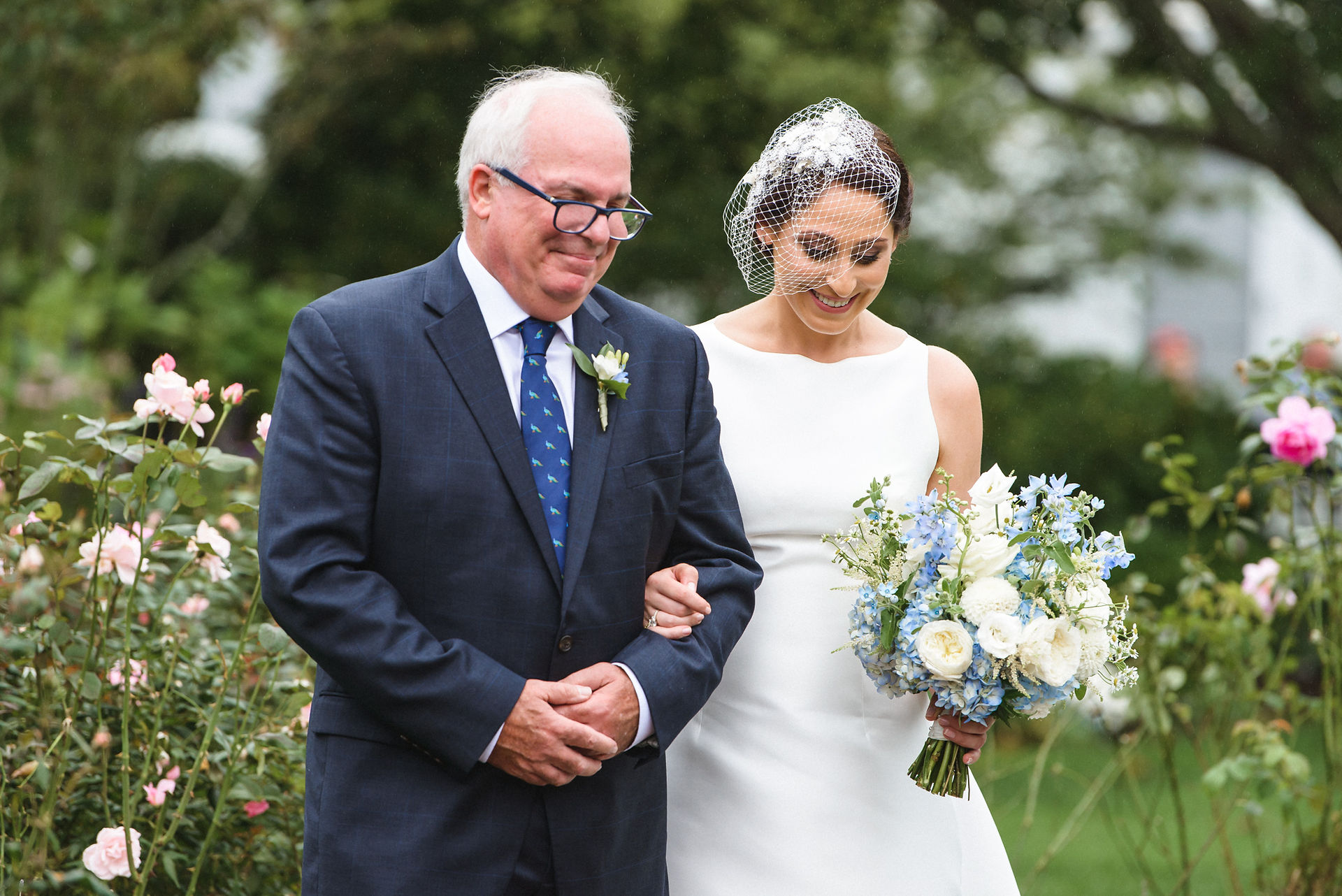 A father escorts his daughter to her wedding ceremony at the Dr. Daniel Fisher House & Gardens  photo by David Welch Photography