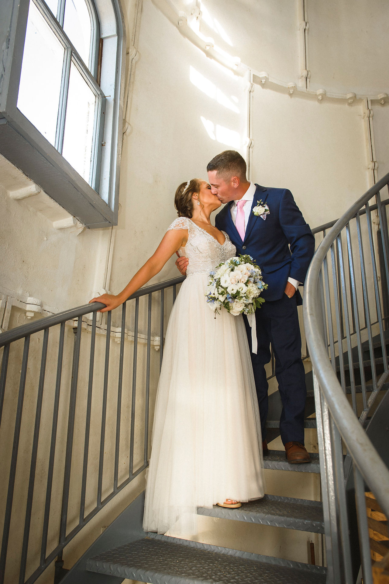 A bride and groom pose for a photo inside the Edgartown Lighthouse photo by David Welch Photography