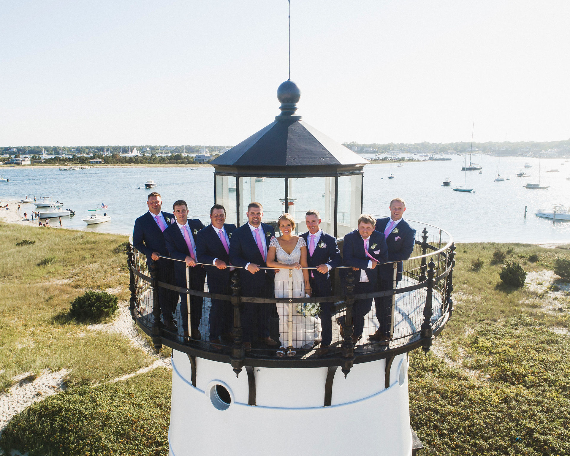 A drone photo of a wedding party on top of the Edgartown Lighthouse photo by David Welch Photography