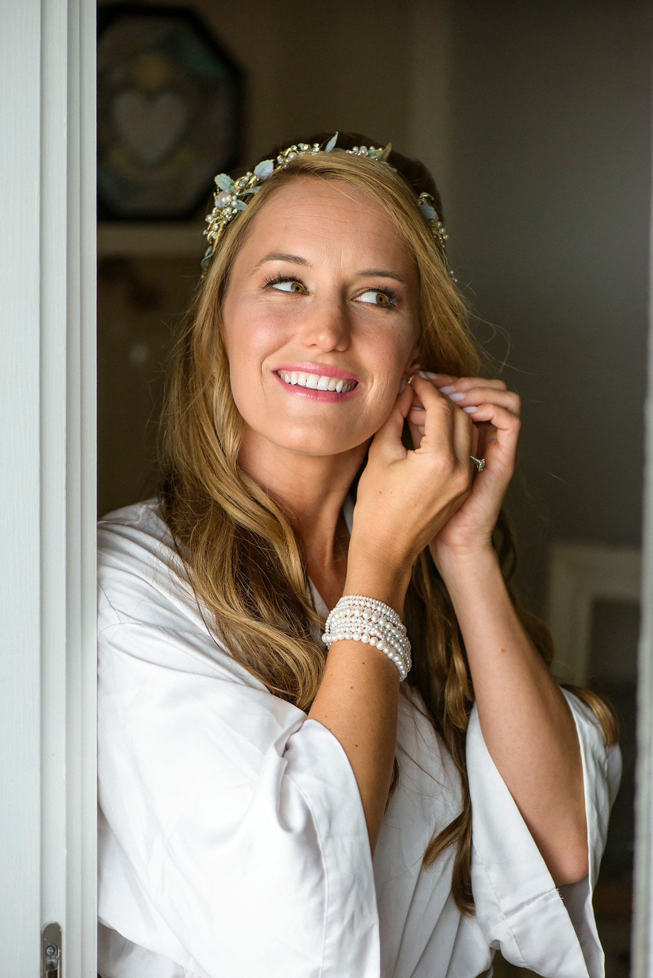 A bride puts on her earring photo by David Welch Photography