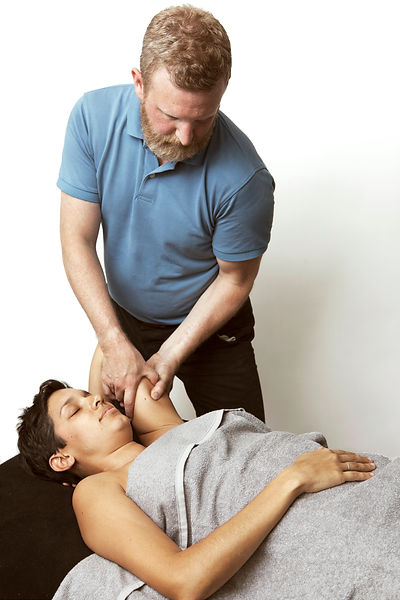 James Hurst providing massage treatment for a client at his Sissinghurst clinic