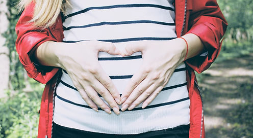 Pregnant woman touching her bump with her hands