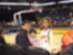 Photo of Richa, her sister, and her dad at a Golden State Warriors game when they were young