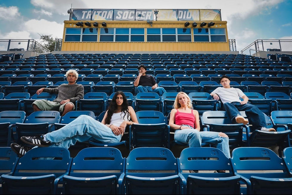 Photo of Committed creative team sitting in a set of bleachers