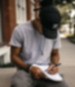 man sitting outside and journaling