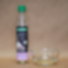 organic garlioil bowl with bottle next to it