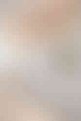 A peek into the bathroom inside the bridal suite of the Selah Event Venue in Pilot Point, TX. The gorgeous bathroom has pink floral wall paper above the white marble counters, and gold floral light fixtures above the sinks. Image captured by Photography of Sarah Mae.