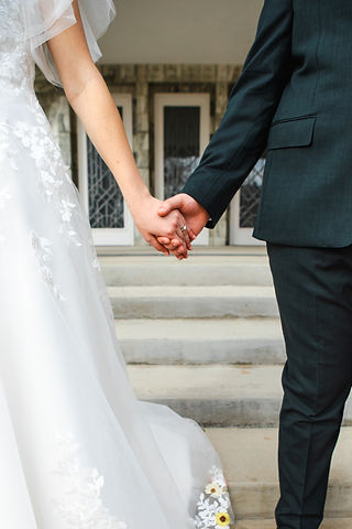 Bride and Groom hold hands in front of the Dallas Texas LDS Temple. Image captured by Wedding Photographer Sarah Mae.