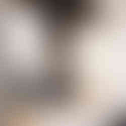 The sleek men's guest bathroom at the Selah Event Venue in Pilot Point, TX. Behind the mirrors is a matte black painted wall, complete with gold and glass light fixtures, and a white marble counter. Image captured by Photography of Sarah Mae.